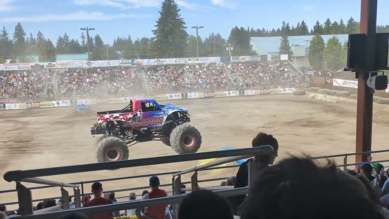 Monster truck loses tire into parking lot