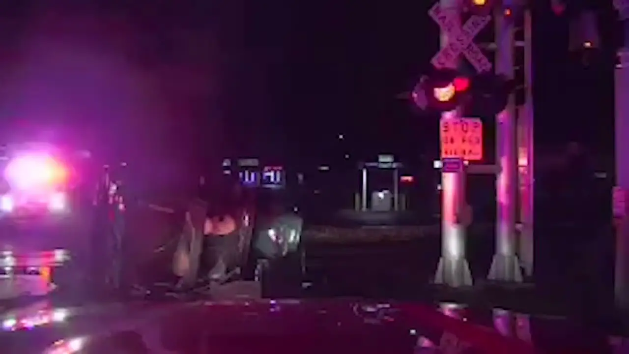 Firefighters rescue man seconds before train hits his Jeep