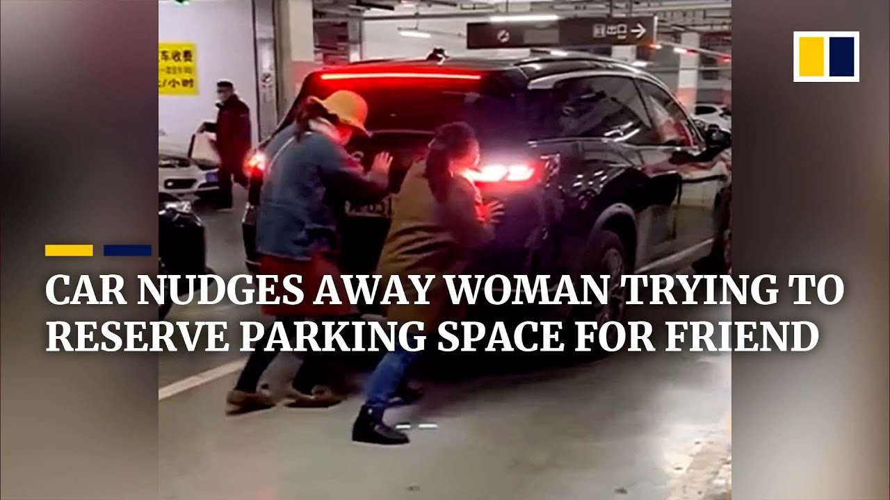 Car nudges away woman trying to reserve parking space for friend in China
